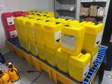 several yellow containers are stacked on top of each other on a pallet