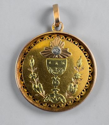 a close up of a gold medal on a white surface