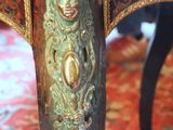 a close up of a table with a gold decoration on it
