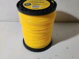 a close up of a spool of yellow thread on a white surface