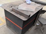 a desk with a chair and a piece of paper on it