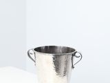 a silver bucket sitting on top of a white shelf