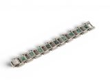 a close up of a bracelet on a white surface