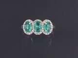 an emerald and diamond three stone ring
