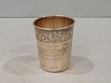 a silver cup that is sitting on a table