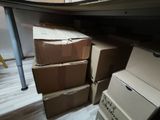 many boxes stacked on top of each other in a room