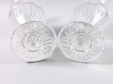 three clear glass cups sitting on top of each other on a white surface
