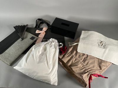 three bags and a purse are sitting on a white surface