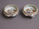 pair of porcelain bowls with flowers and birds on them on a table