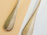 two spoons and a fork on a table