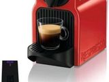 an image of a coffee machine with a cup of coffee next to it