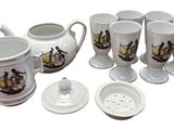 a lot of coffee cups and a teapot on the table