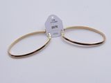 a pair of gold hoop earrings on a white background