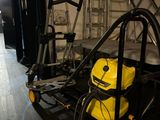 a yellow vacuum sitting on a cart in a room
