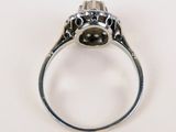 a close up of a ring with a black diamond