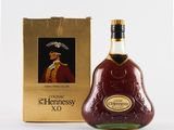 the bottle of hennessy xo is next to the box
