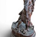 statue of a man and a woman kissing on a rock