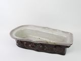 a white and brown ceramic rectangular dish on a white surface