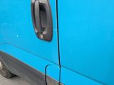a close up of a blue van with a door handle