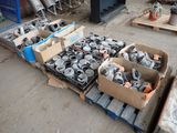 several boxes of assorted metal items on a pallet in a warehouse