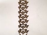 an image of a metal wall hanging on a white wall