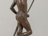 bronze statue of a man with a bow and arrow on a table