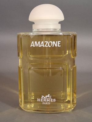 an image of a bottle of perfume sitting on top of a table