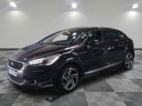 a black car is parked in a large room with a checkered floor