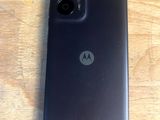 a close up of a motorola phone on a wooden table