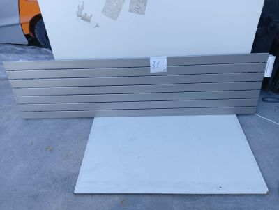 a white refrigerator sitting on top of a table next to a truck