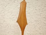 wooden sculpture of a woman with a bird on her head