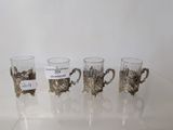 four cups that are sitting on a glass table