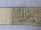 an open book with a drawing of a man in a forest