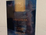 the perfume bottle of shalimar is sitting on the table