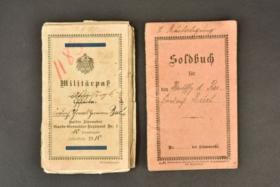 two old books sitting on top of a table next to each other