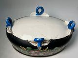 an image of a black and white bowl with blue handles