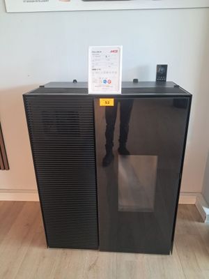 a black refrigerator sitting in the corner of a room