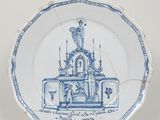 une vieille assiette bleue et blanche sur laquelle est représentée une église