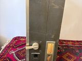 a close up of a metal door handle on a rug