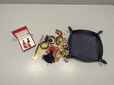 a small box of jewelry on a table next to a pair of scissors and a pair of scissors