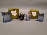 three bottles of perfume sitting next to each other on a table