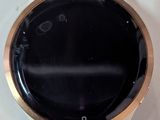a close up of a smart watch on a white surface