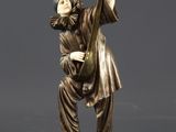 statue of a man playing a musical instrument on a rock