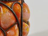 a vase that has a bunch of oranges inside of it