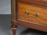 a wooden chest of drawers with brass hardware on it