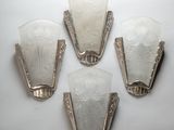 three art deco wall sconces with frosted glass shades on a white background