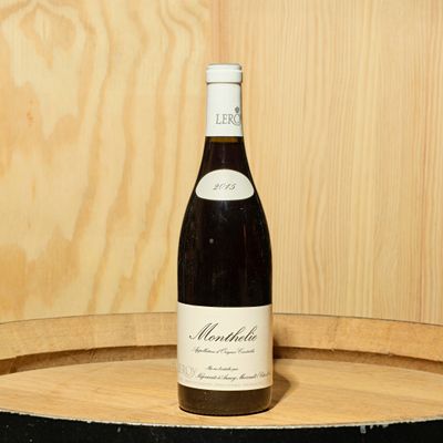 une bouteille de vin posée sur un tonneau