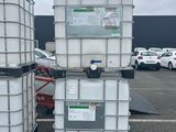 two large white containers sitting on top of each other in a parking lot