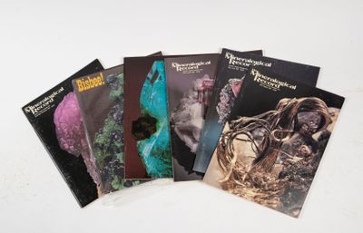 four books on a table with a white background and a white background