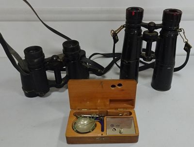 a small wooden box with a watch and a pair of binoculars